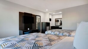 A hotel room with two beds, a desk, a television, a mirror, and a small refrigerator. - Motel 6 Eureka, CA – Redwood Coast (Eureka)