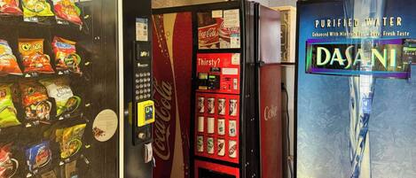 A vending machine with snacks and a Coca-Cola machine.