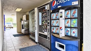 A Pepsi vending machine and a refrigerated display case in a commercial setting. - Super 8 by Wyndham Petaluma (Petaluma)