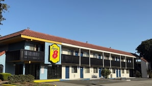 A motel with a prominent 'Super 8' sign, multiple balconies, and a parking lot. - Super 8 by Wyndham Petaluma (Petaluma)