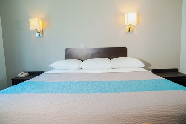 Desk, laptop workspace, bed sheets