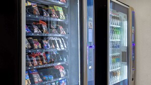 A vending machine with snacks and a water dispenser. - Motel 6 Carson City, NV (Carson City)