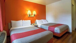 A hotel room with two beds, a wall-mounted lamp, and a vent. - Motel 6 Prescott, AZ (Prescott)