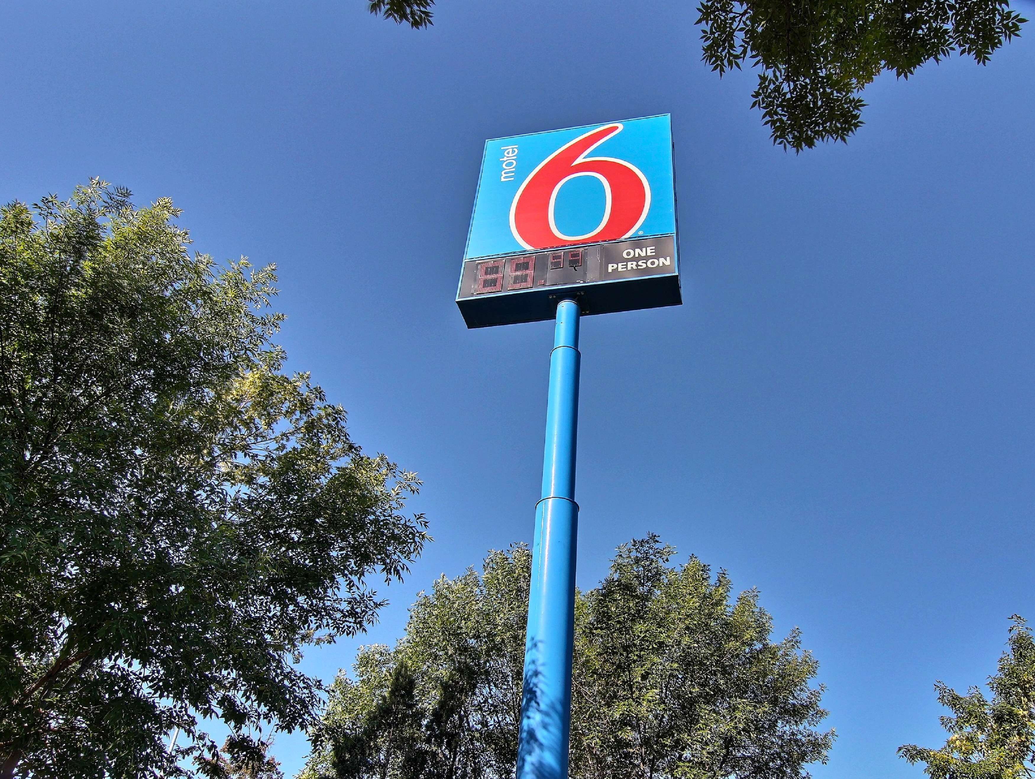 A motel sign with the number 6 and the words "ONE PERSON" indicating the maximum occupancy.