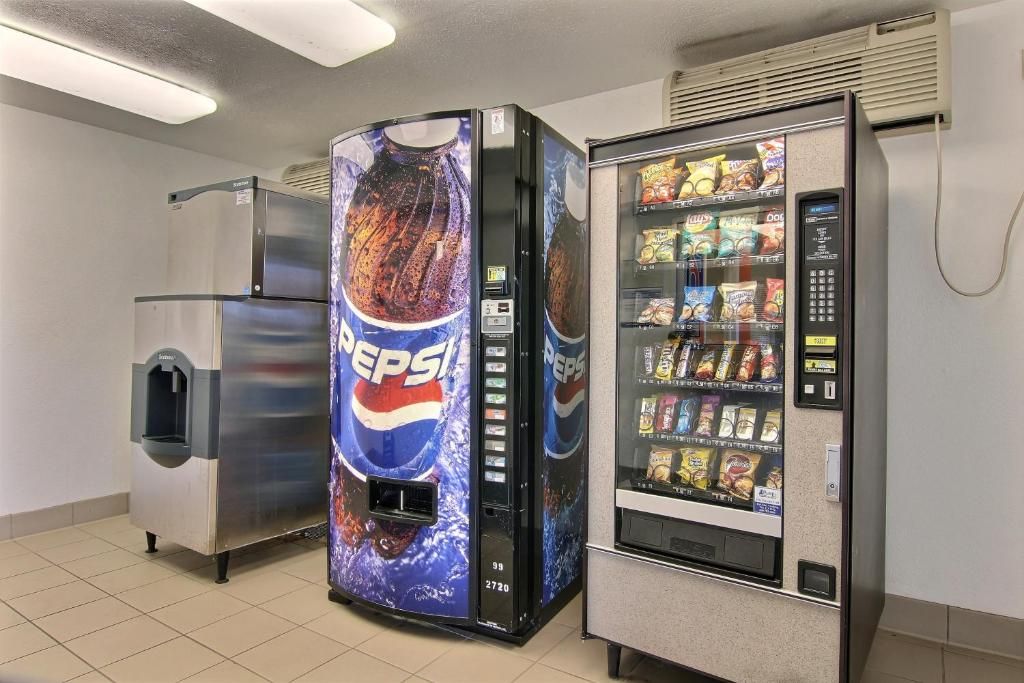 A vending machine with a Pepsi logo, a water dispenser, and a refrigerator.