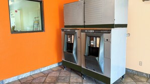 A row of ice cube dispensers with a window above them. - Luxury Inn by OYO Albany (Albany)
