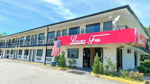 A two-story motel with a red awning labeled "Luxury Inn." - Luxury Inn by OYO Albany (Albany)