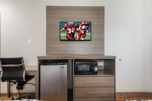 A kitchenette with a microwave, a dishwasher, and a TV mounted on the wall. - Red Roof Inn San Antonio E – Frost Bank Center (San Antonio)
