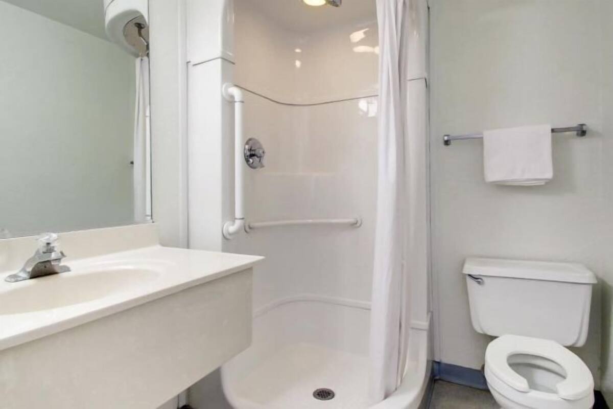 Ducha y bañera combinadas, toallas y papel higiénico