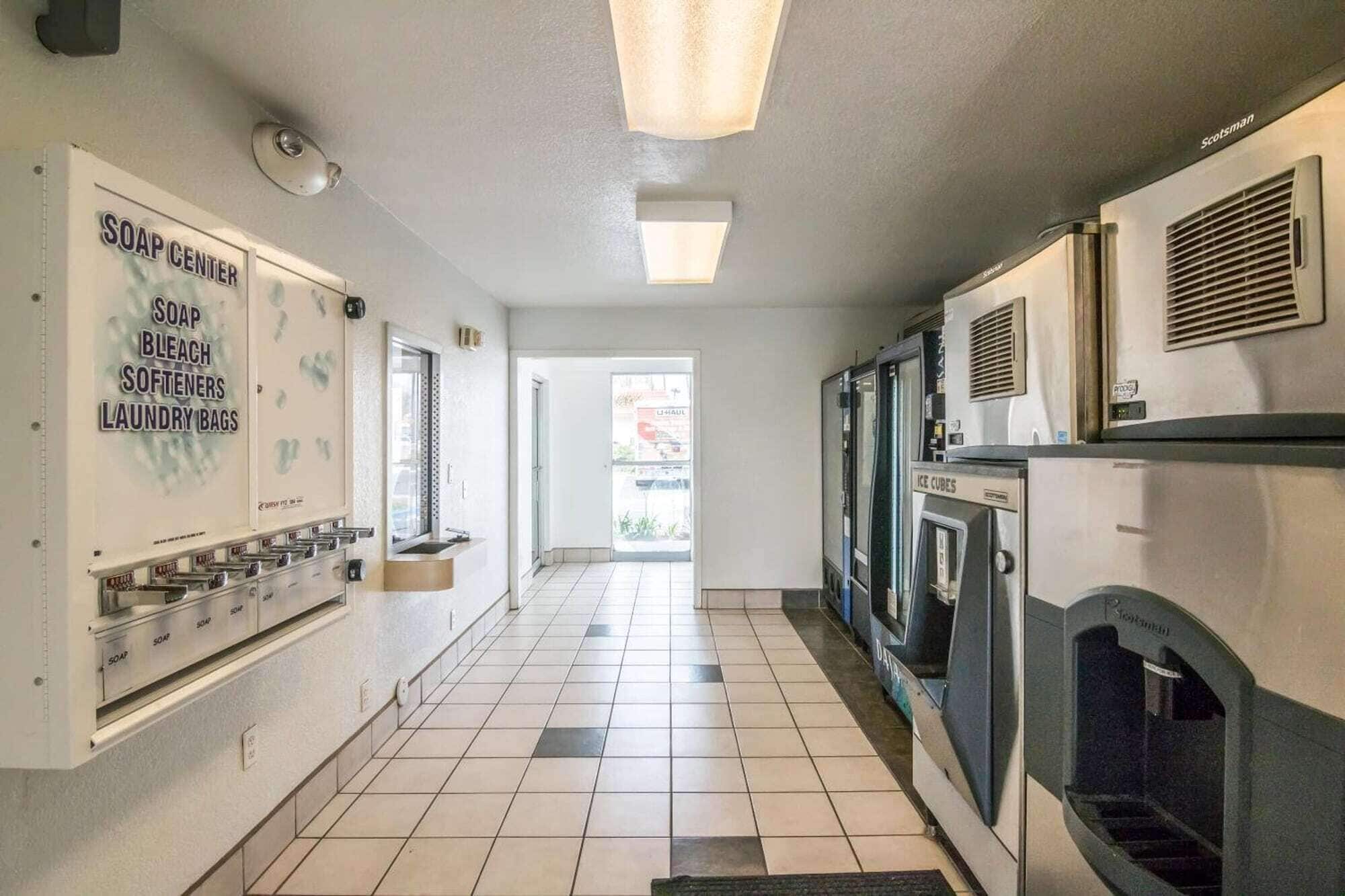 A laundry facility with a soap center, ice cubes dispenser, and a view to the outside.