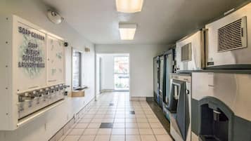 A laundry facility with a soap center, ice cubes dispenser, and a view to the outside.