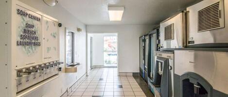 A laundry facility with a soap center, ice cubes dispenser, and a view to the outside.