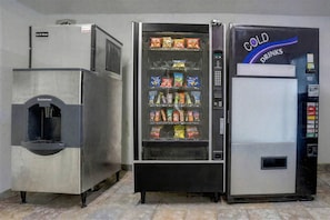 Una máquina expendedora con opciones de bocadillos y un dispensador de agua.