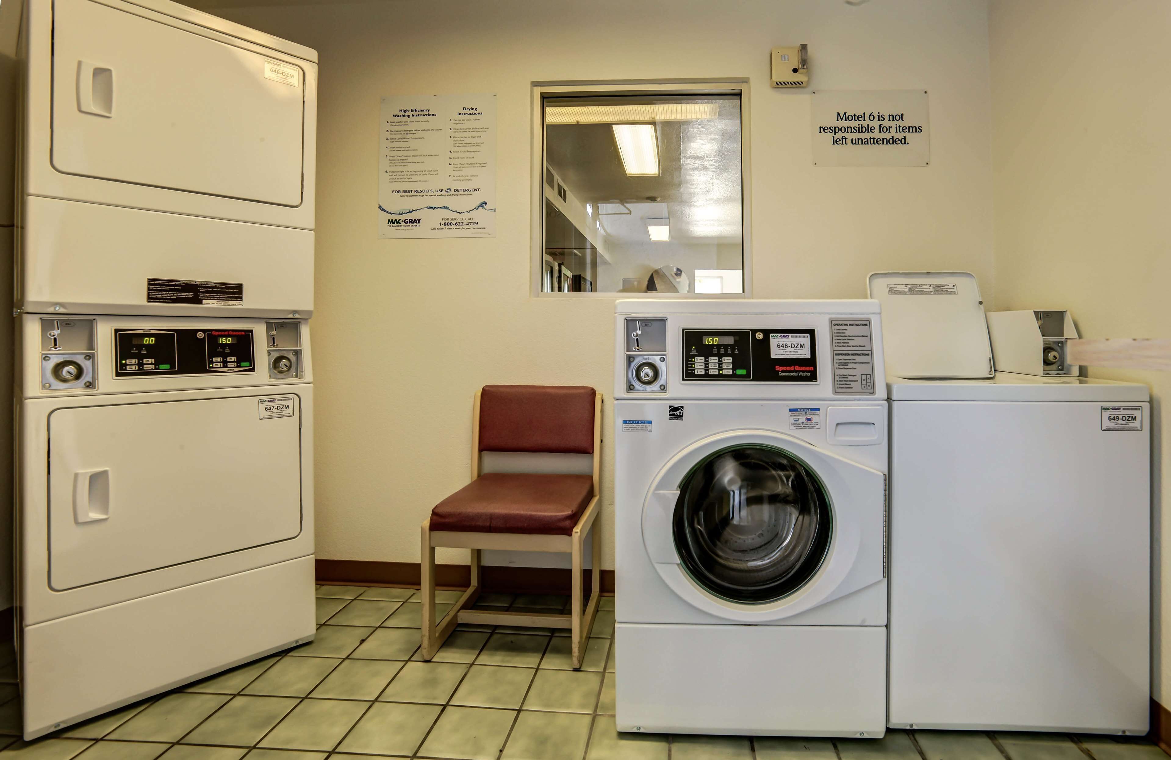 A laundry room with a washing machine, dryer, and folding station.