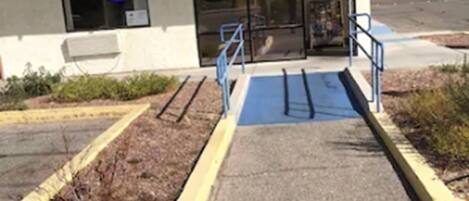 A building with a storefront, a number 1031, and a blue ramp leading to the entrance.