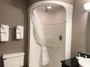 A bathroom with a shower, toilet, and sink. - Motel 6 Cheyenne WY (Cheyenne)