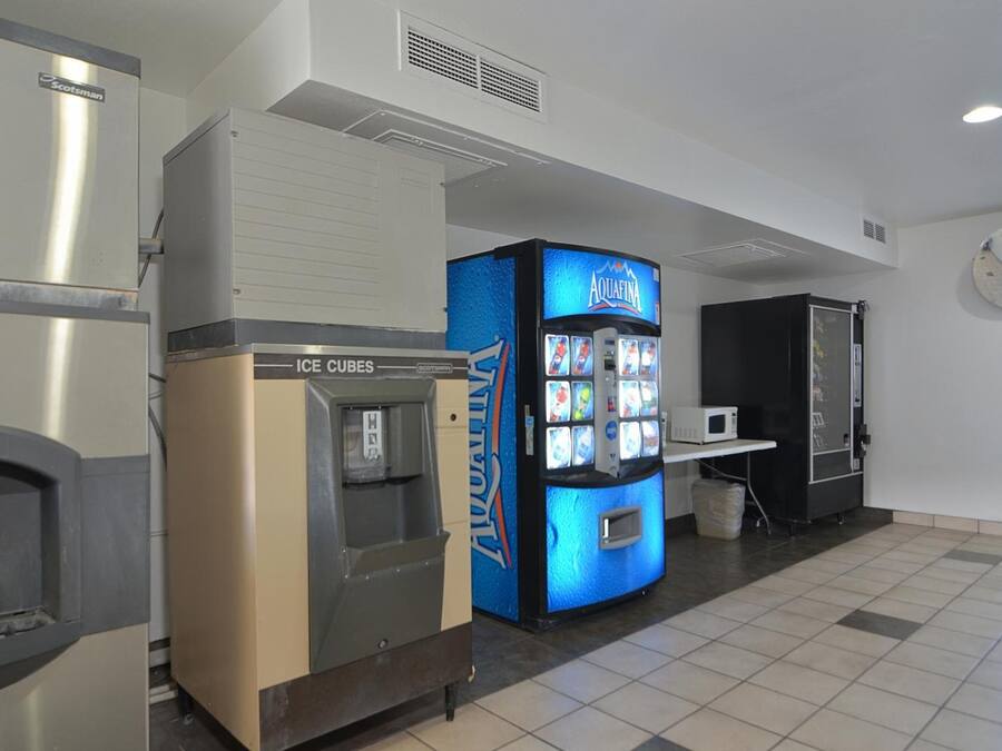 A vending machine area with an ice cube dispenser and a water dispenser.