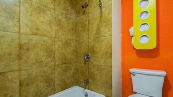 A bathroom with a shower, a bathtub, and a toilet.