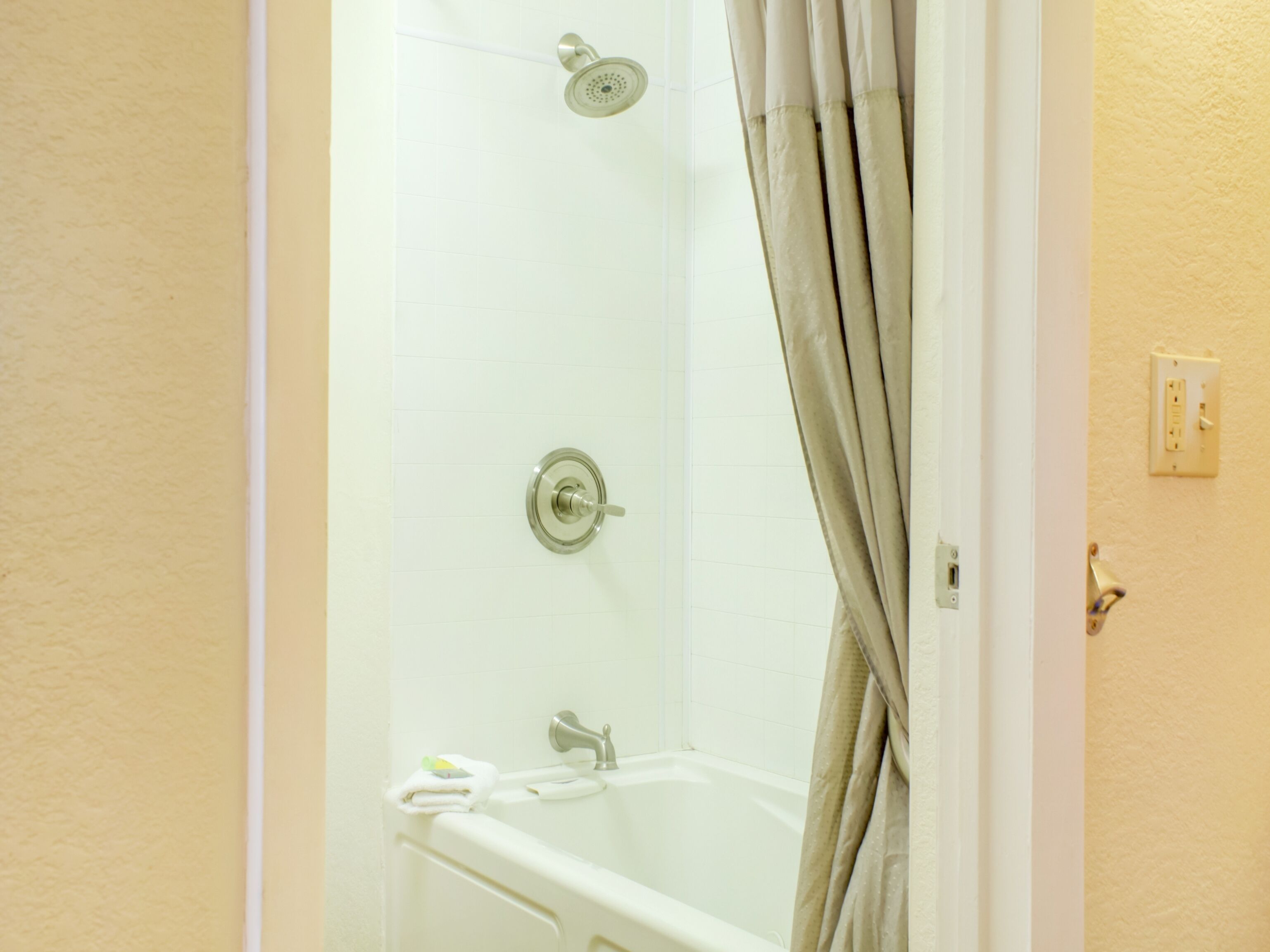A bathroom with a shower, a bathtub, and a toilet.