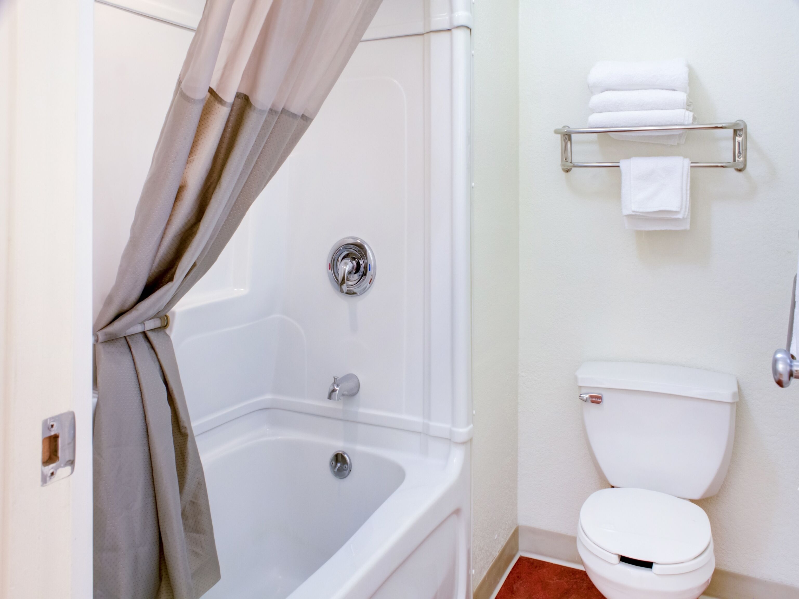 Une salle de bain avec une baignoire, des toilettes et un porte-serviettes.