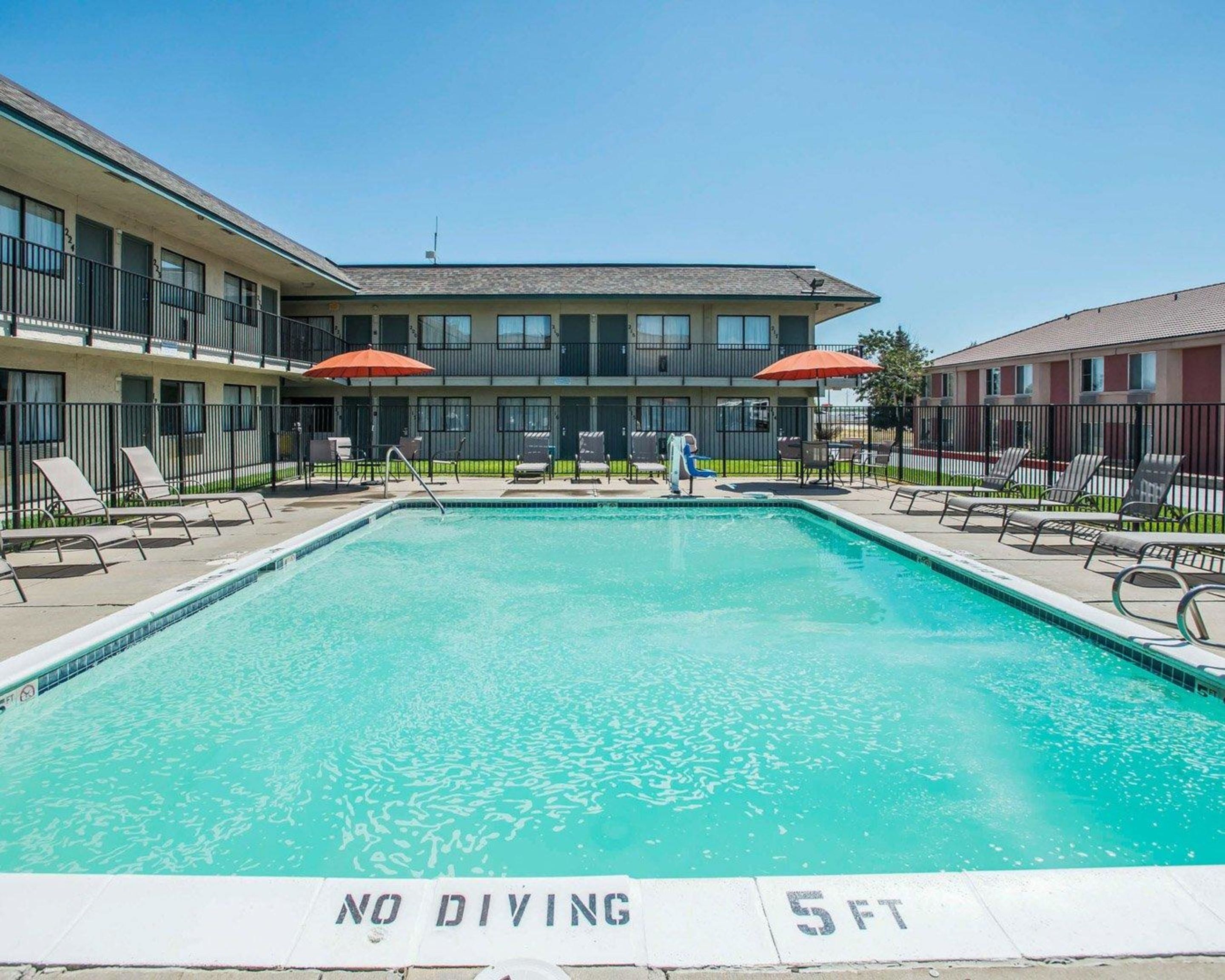 A swimming pool with a 'NO DIVING' sign and a depth marker of '5 FT'.