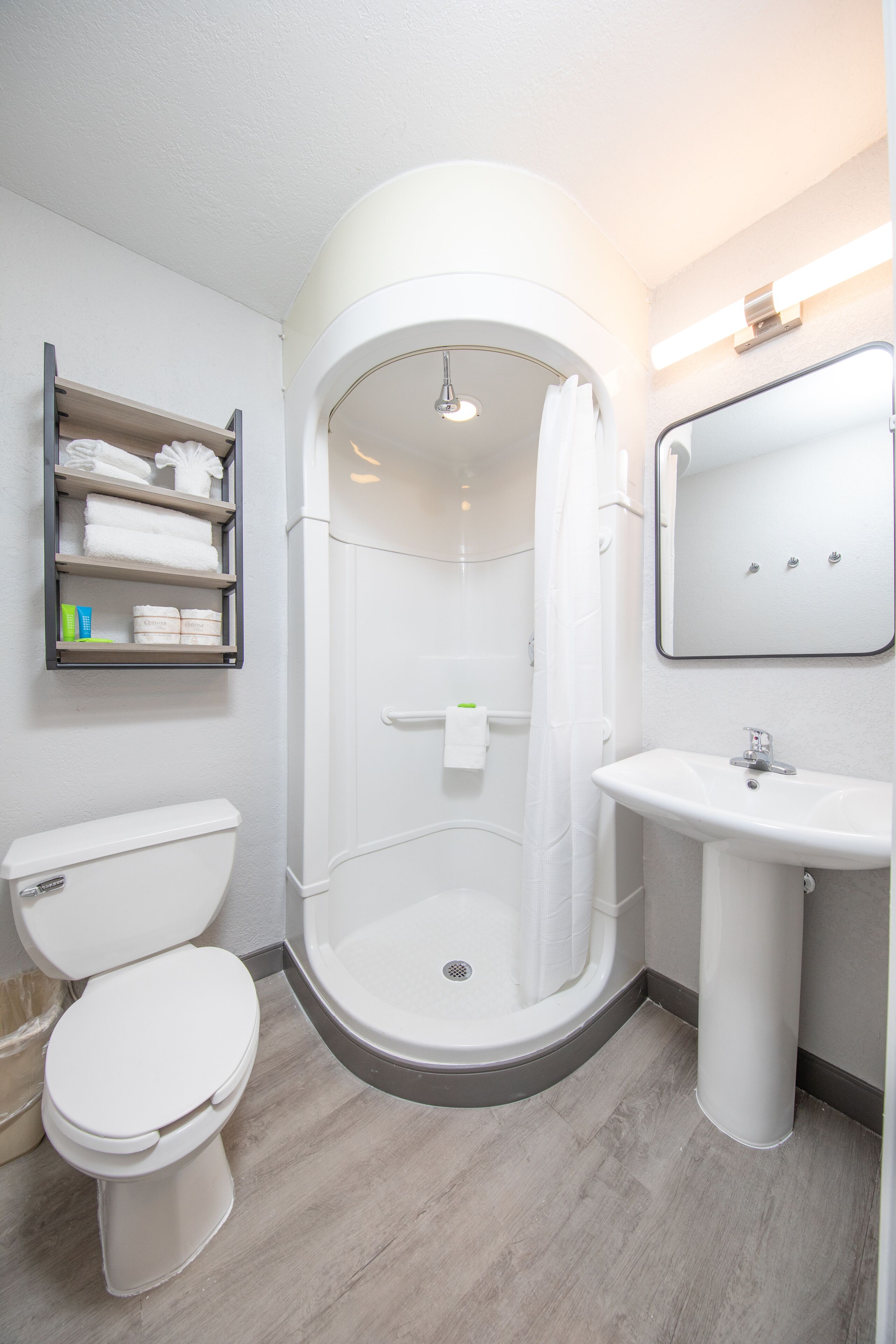 Un baño moderno con inodoro, ducha y lavamanos.