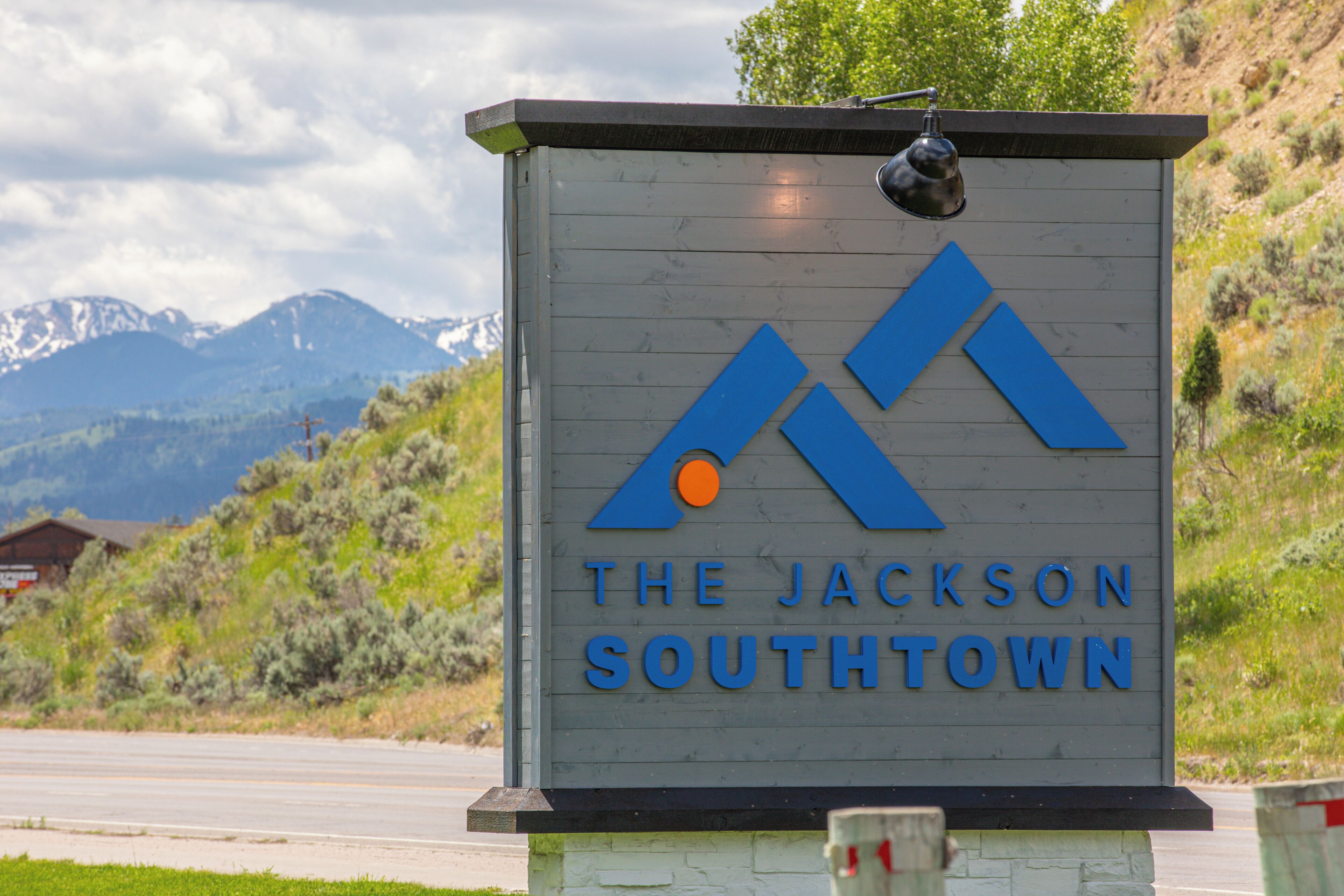 A sign for The Jackson Southtown with a mountain backdrop.