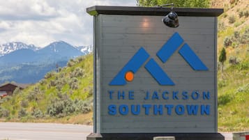 A sign for The Jackson Southtown with a mountain backdrop.