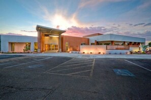 A modern building with a large entrance and a parking lot. - Motel 6 Page, AZ (Page)
