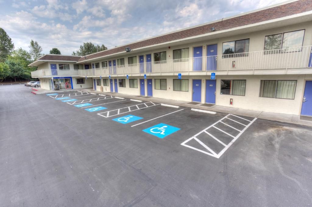 A motel with a parking lot marked for disabled parking.