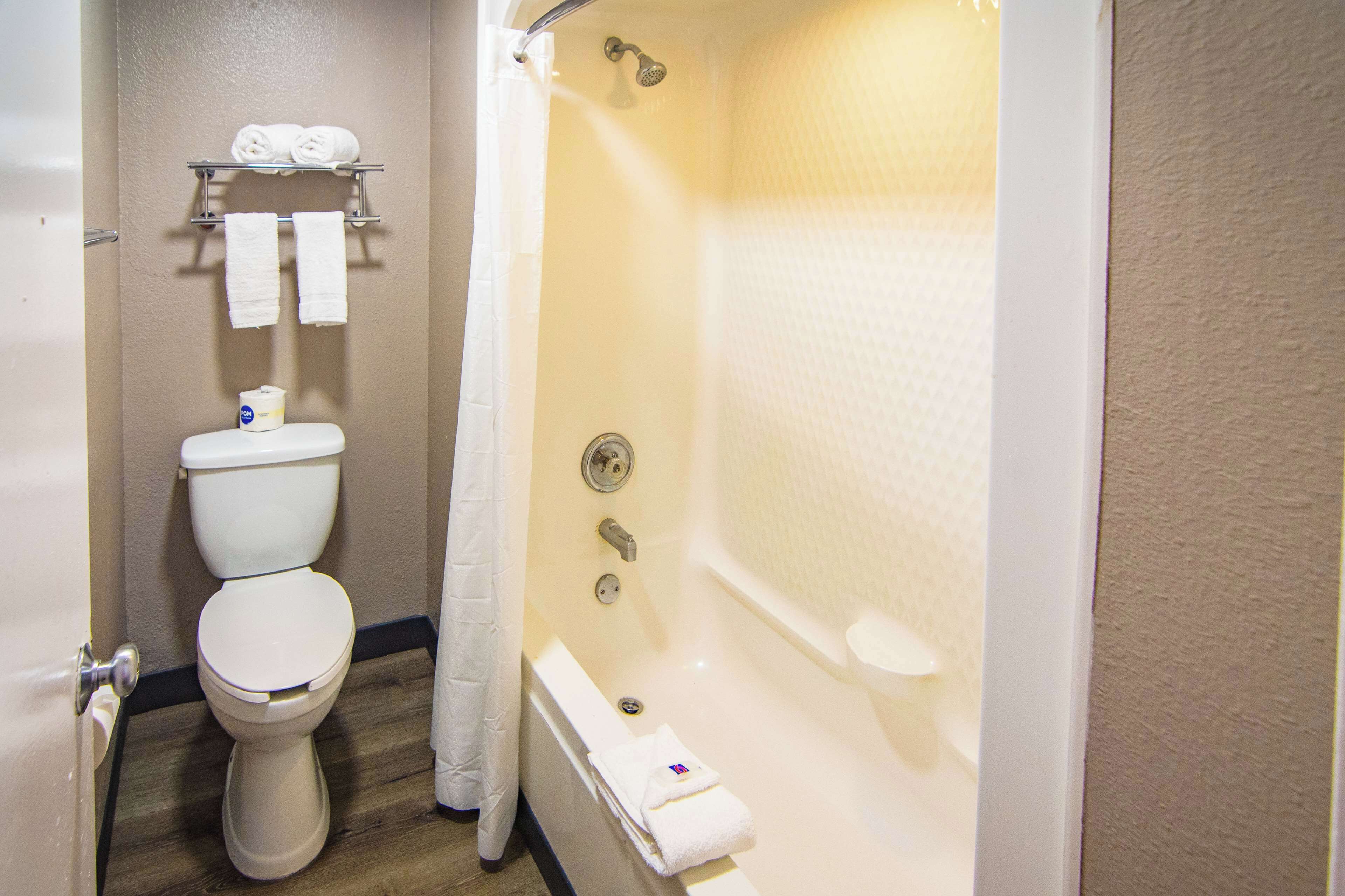 A bathroom with a toilet, a shower, and a bathtub.