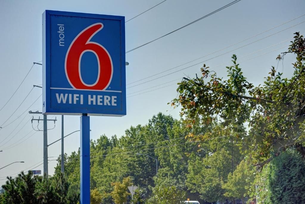 A motel sign with the number 6 and the text 'WIFI HERE'.