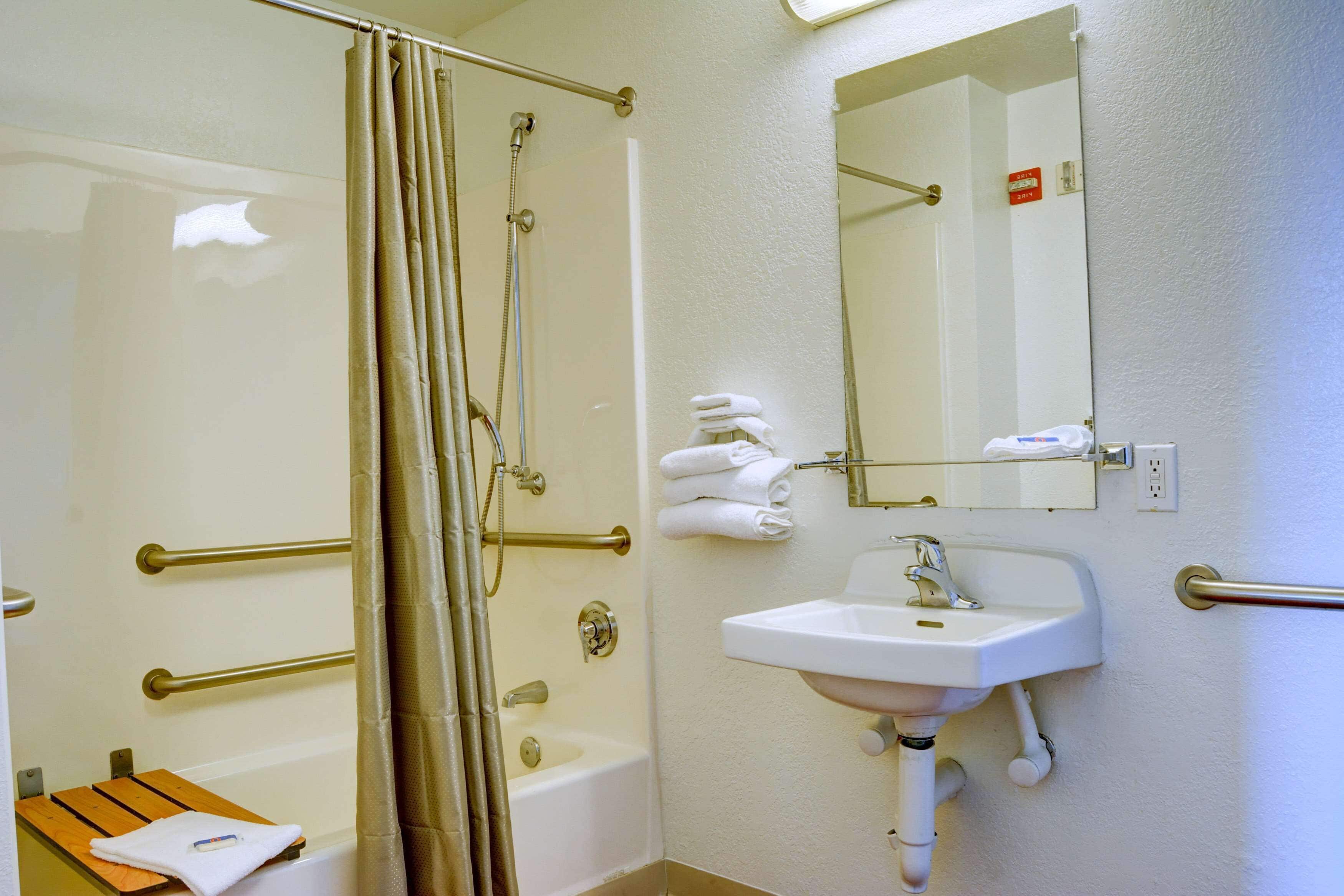 A bathroom with a bathtub, shower, and sink.