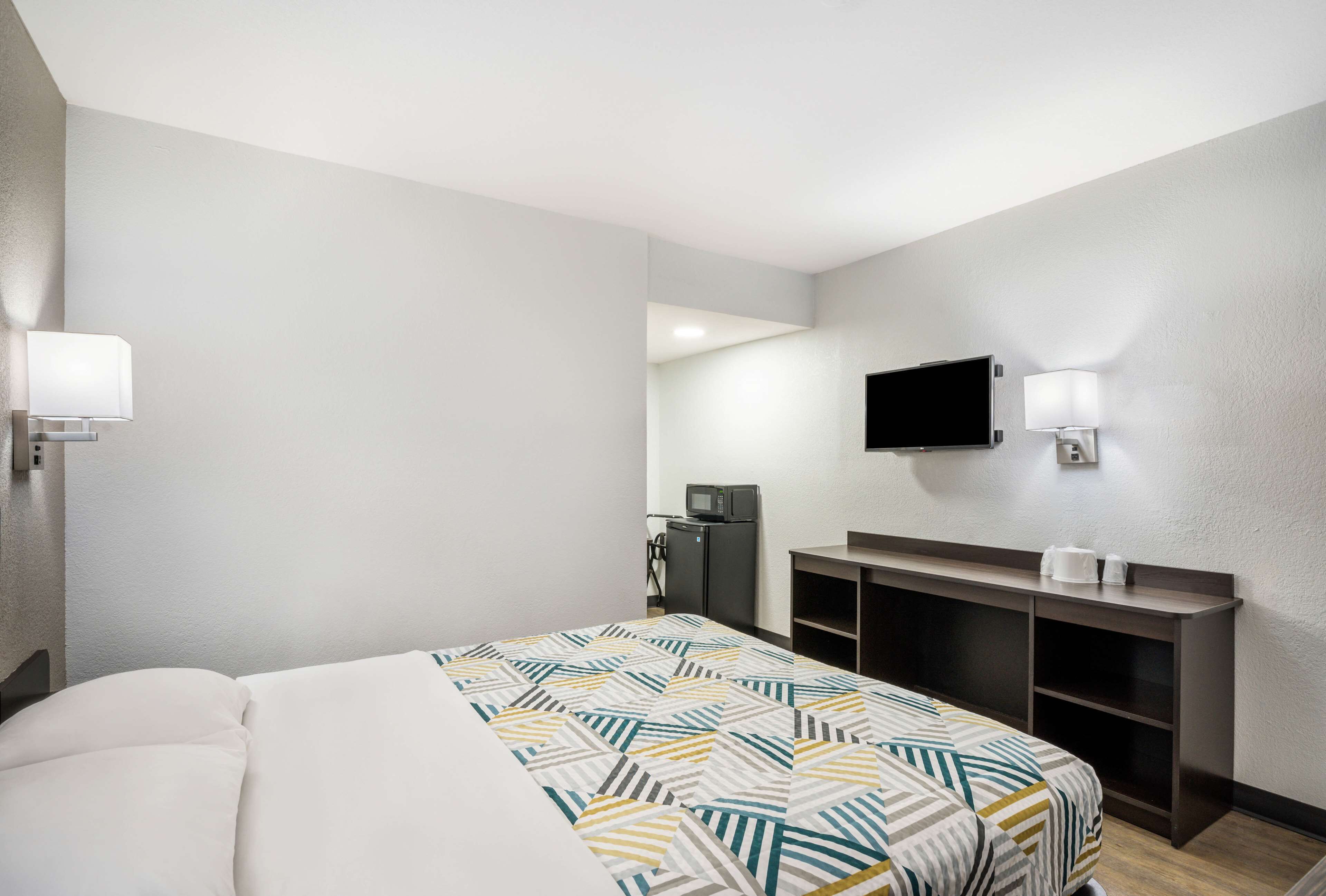 Desk, laptop workspace, bed sheets