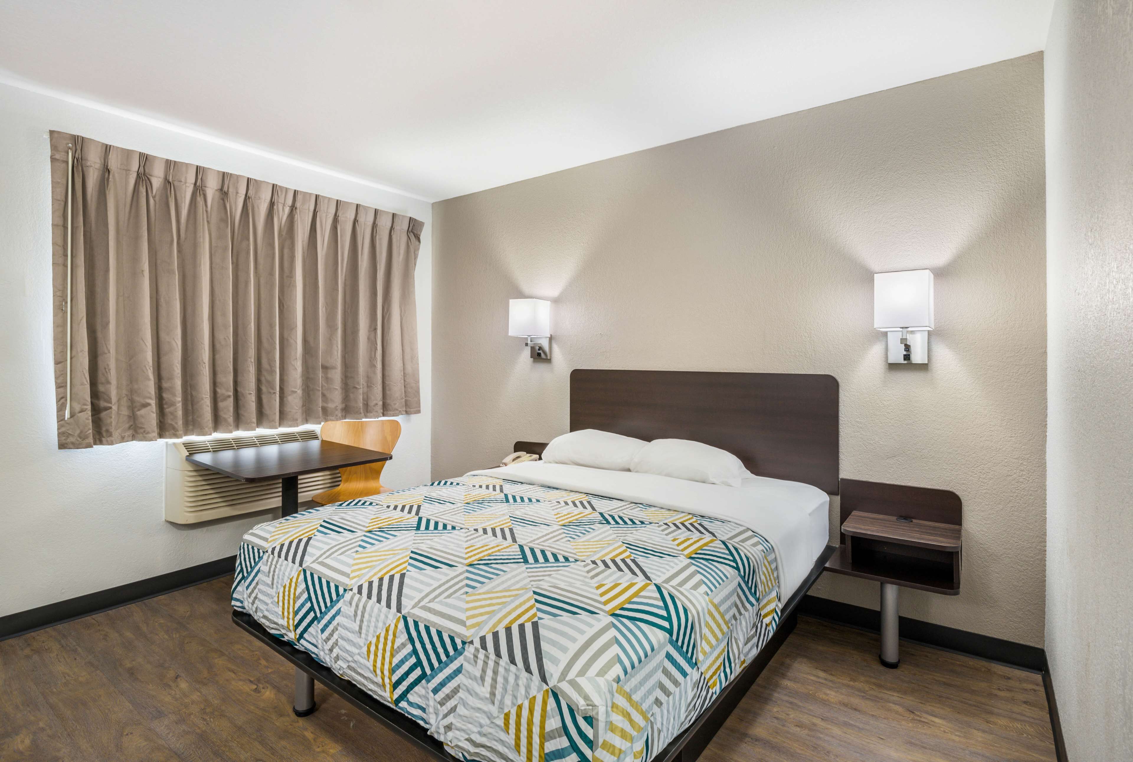 Desk, laptop workspace, bed sheets