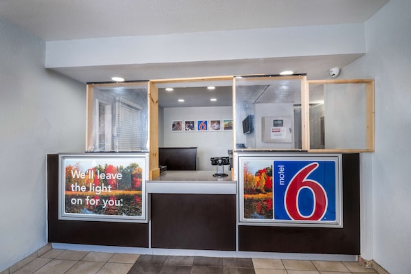 A reception desk with a sign reading "We'll leave the light on for you."