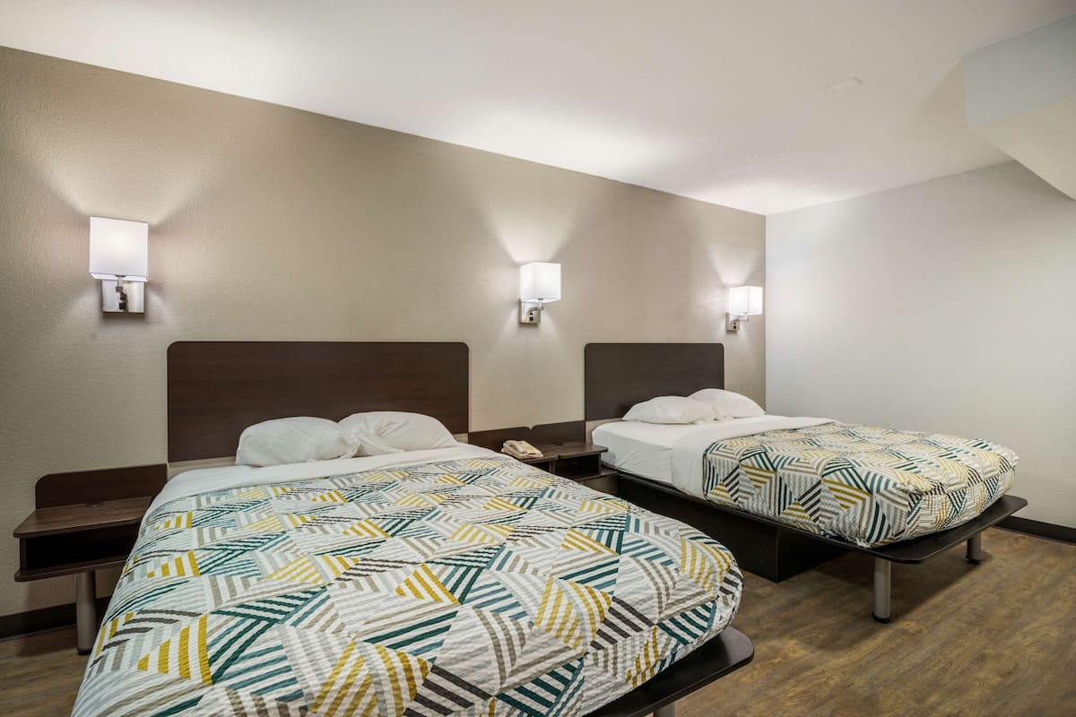 Desk, laptop workspace, bed sheets