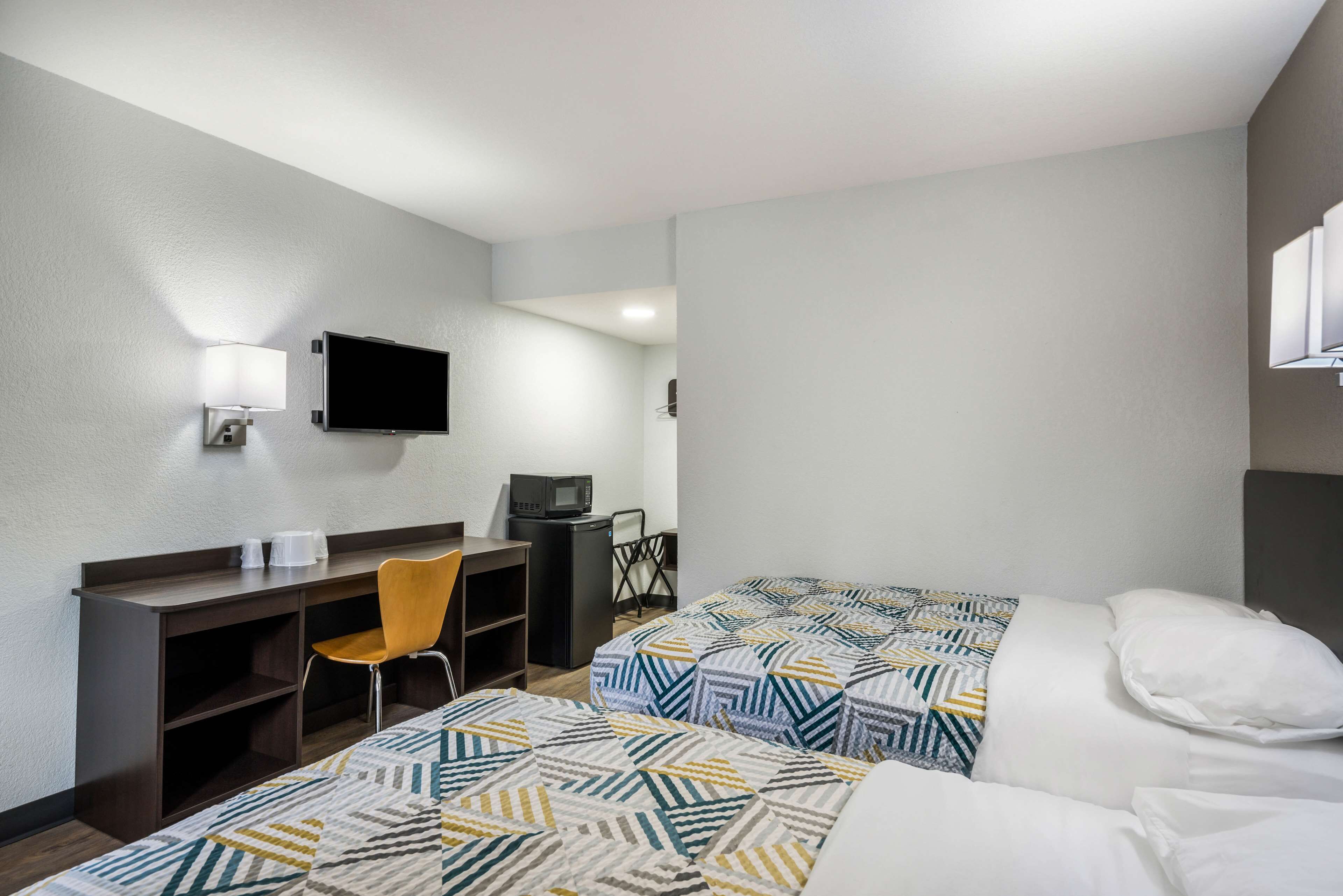 Desk, laptop workspace, bed sheets