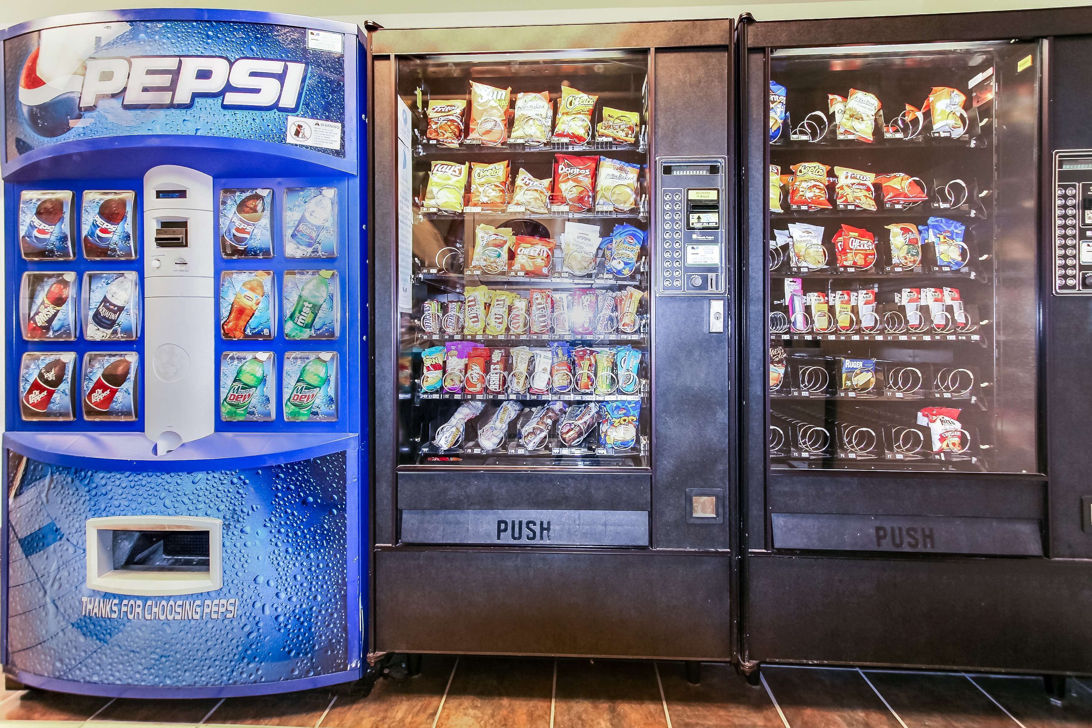Een automaat met een Pepsi logo en diverse snacks en dranken.