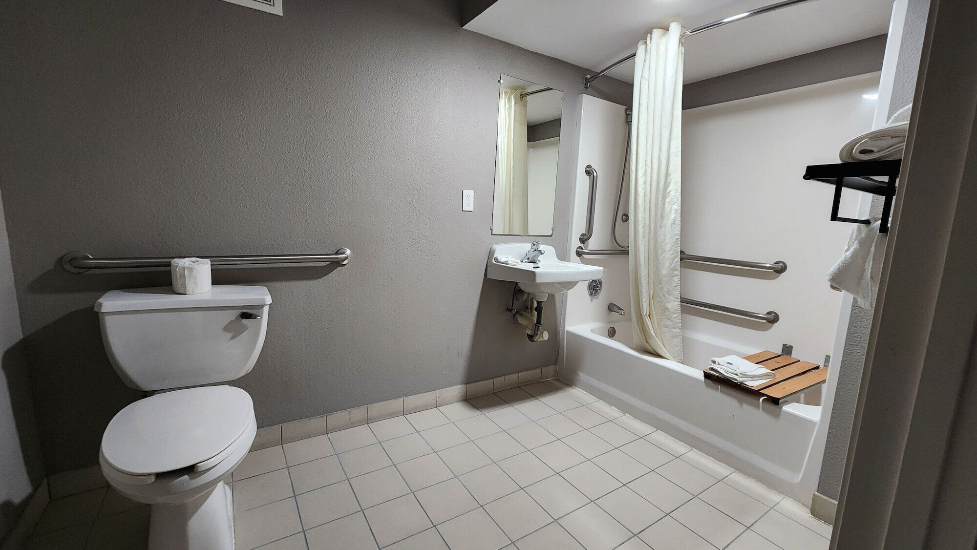 A bathroom with a toilet, sink, and bathtub.