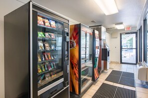 A vending machine area with snack options and a clear exit sign. - Motel 6 Sparks, NV - Airport - Sparks (Sparks)