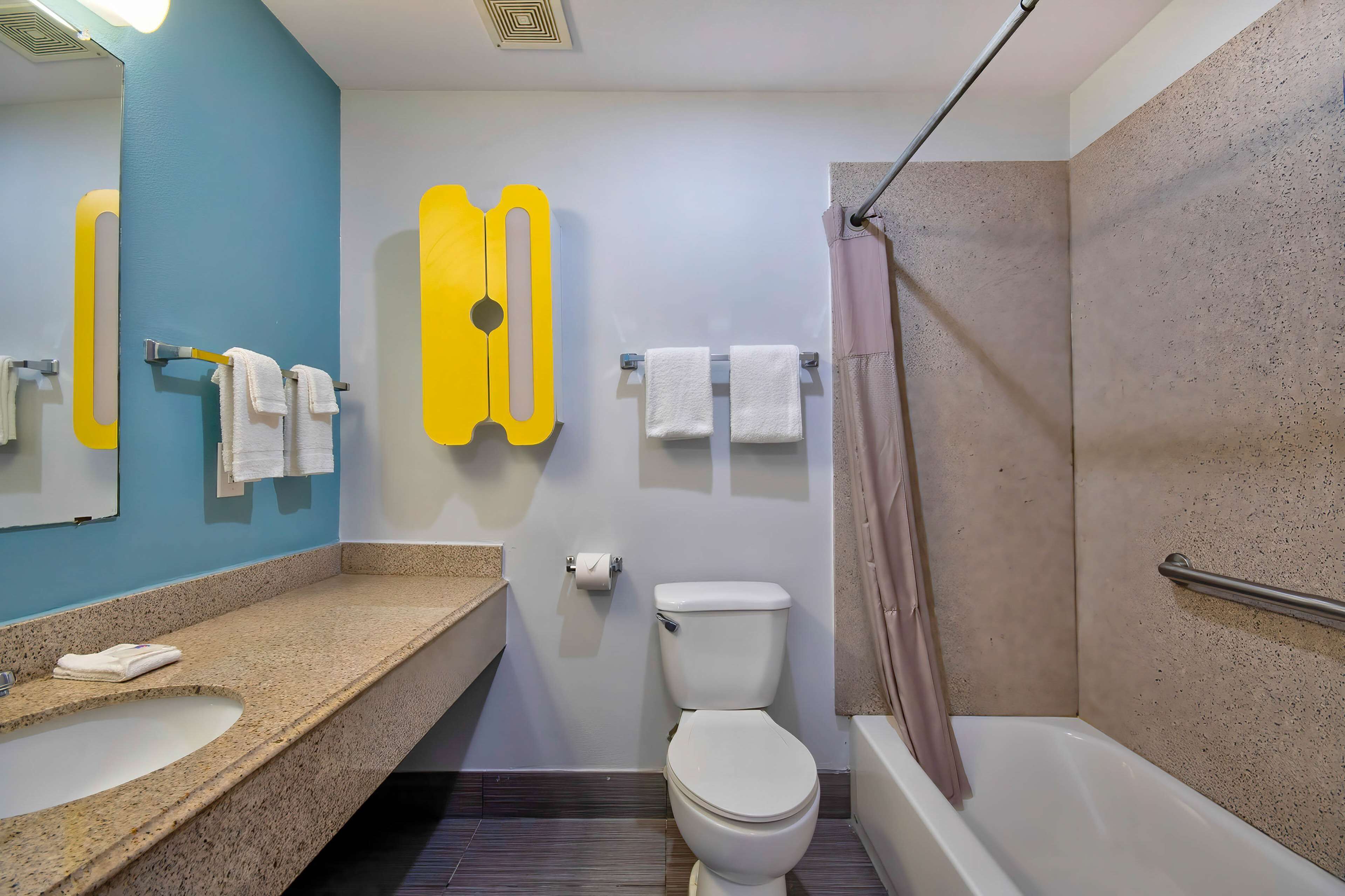 A bathroom with a sink, toilet, and bathtub.