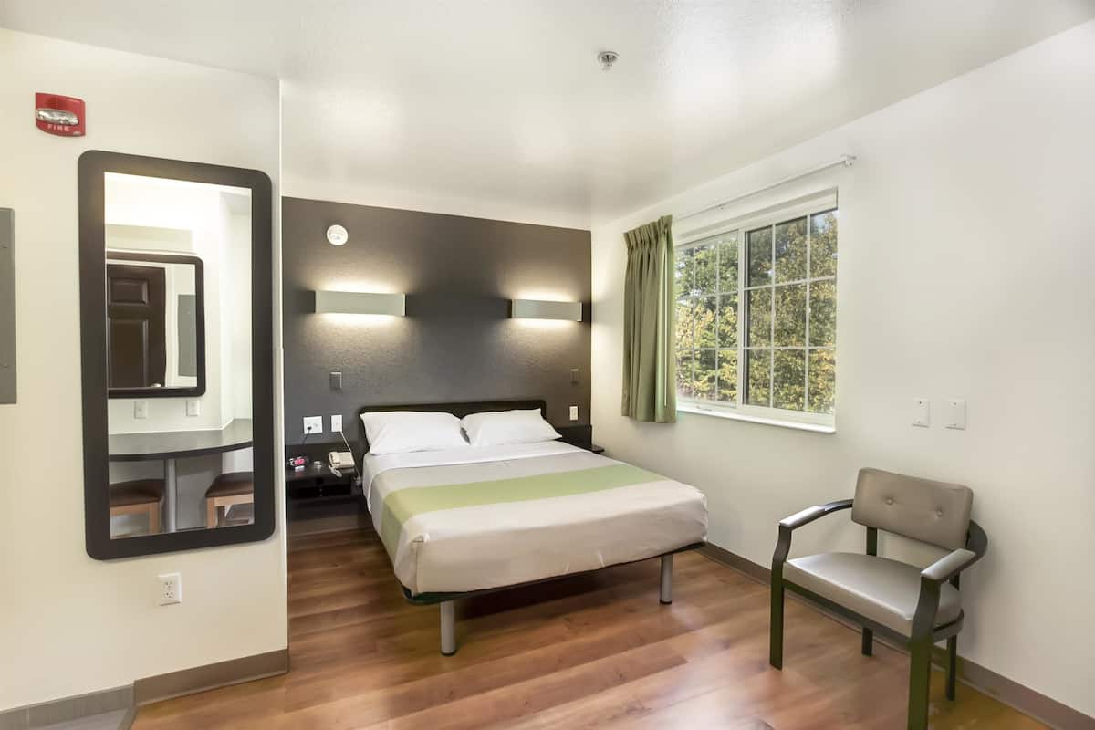 Desk, iron/ironing board, bed sheets, alarm clocks