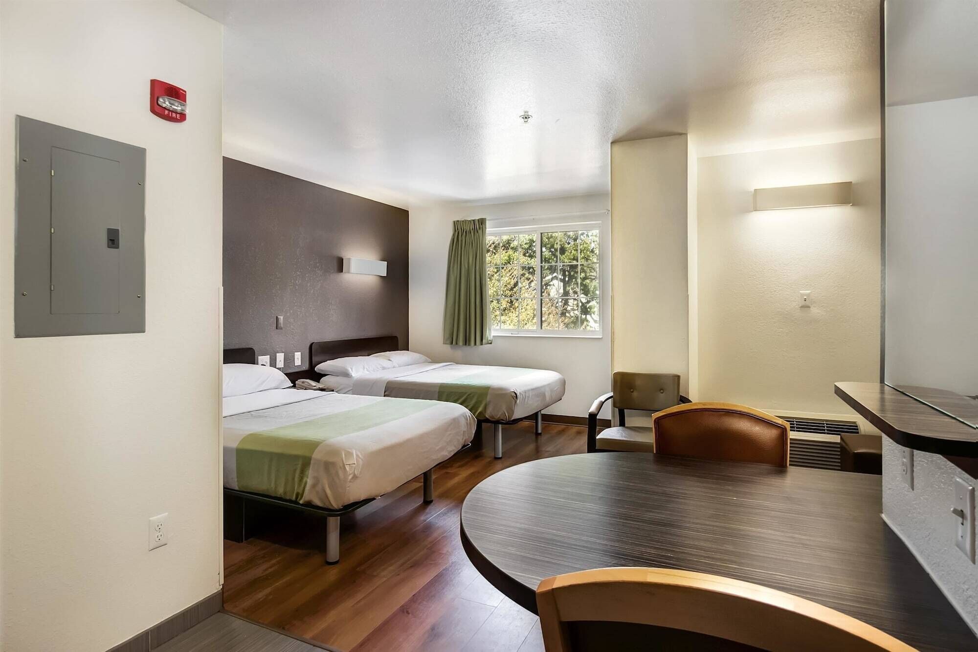 Desk, iron/ironing board, bed sheets, alarm clocks