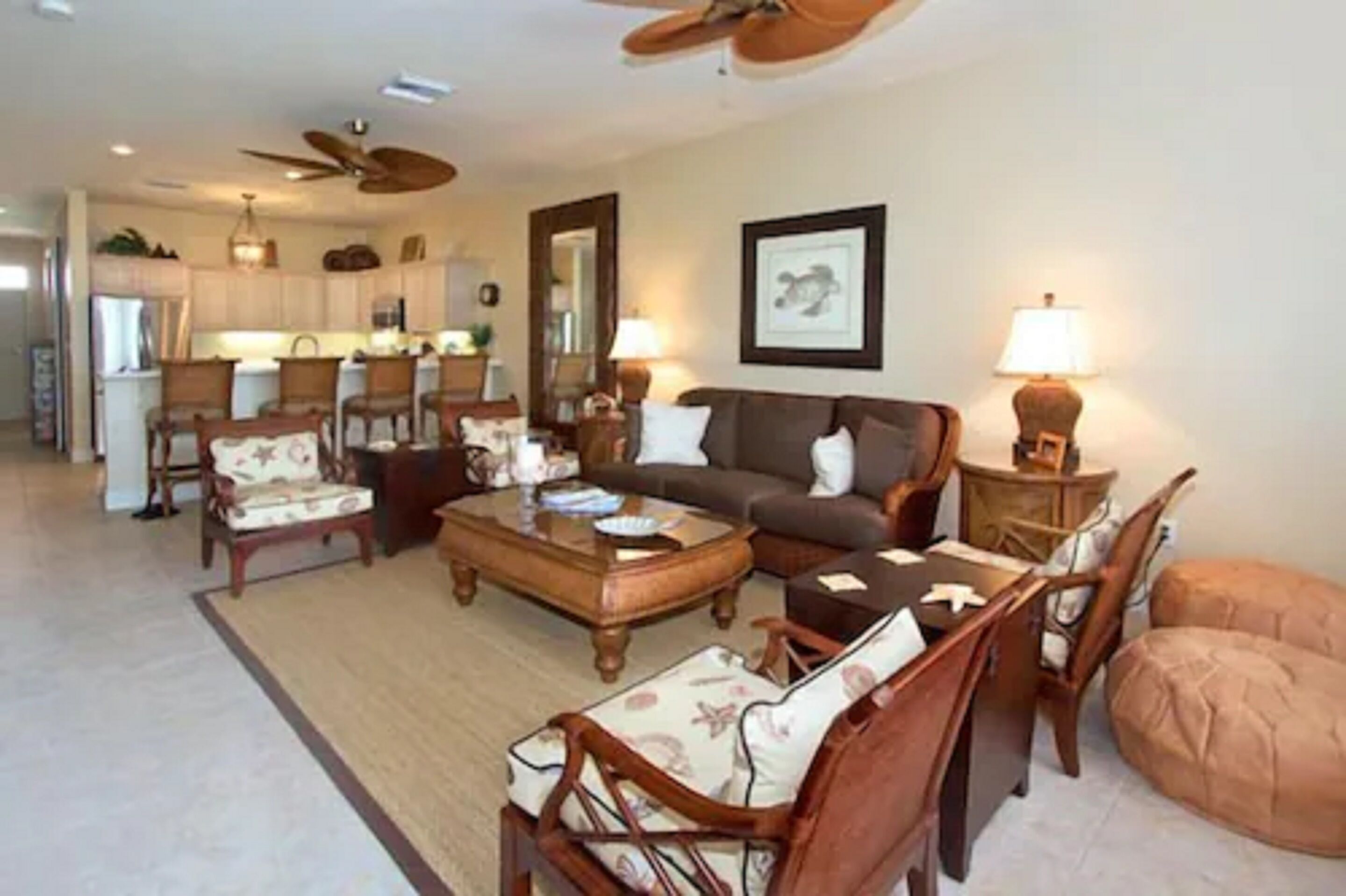 A spacious living room with a sofa, chairs, a coffee table, and a dining area with chairs and a table.