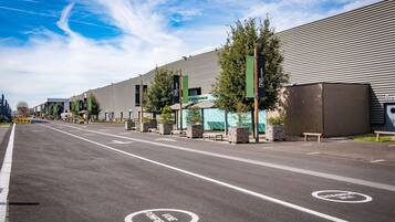 A modern building with a parking lot and designated bike lanes.