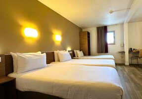 Premium bedding, desk, laptop workspace, blackout drapes