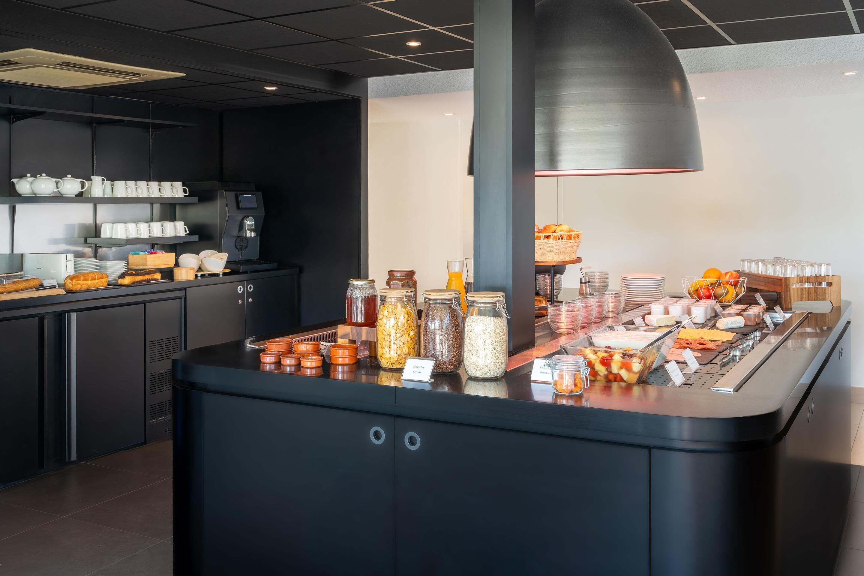 A buffet area with various food items and condiments.