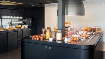 A buffet area with various food items and condiments.