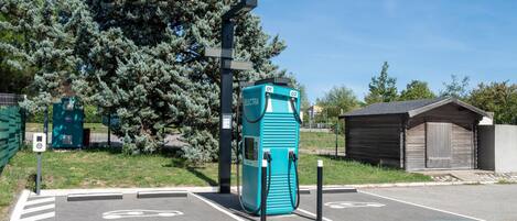 A parking area with electric vehicle charging stations marked as 01 and 02.